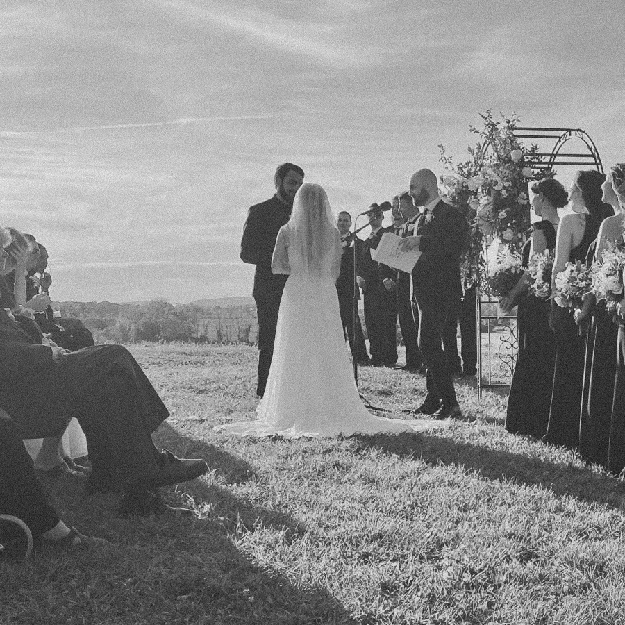Outdoor wedding ceremony with bride and groom.