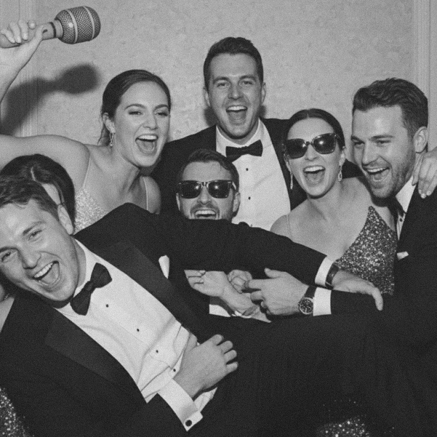 Wedding guests having fun at the photobooth.